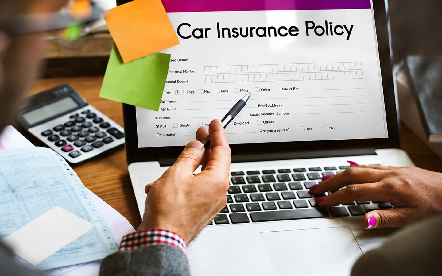 Reviewing a car insurance policy and excess details on a laptop.