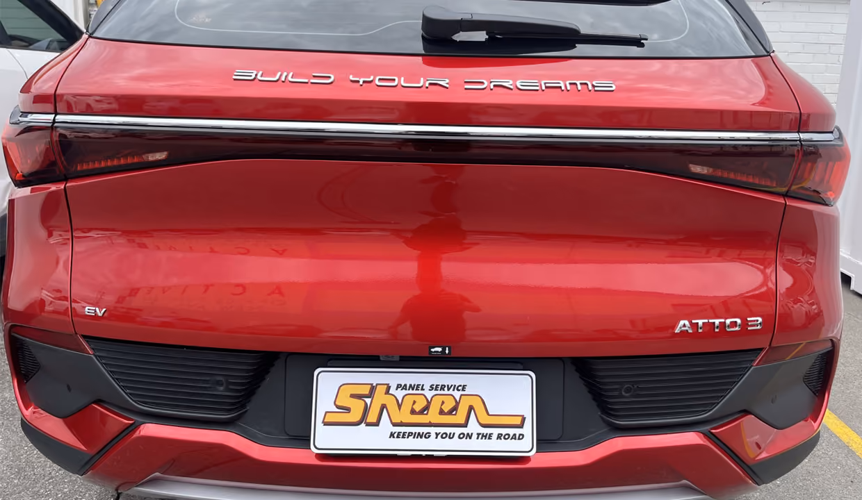Fully repaired red BYD Atto 3 electric vehicle after collision repairs.
