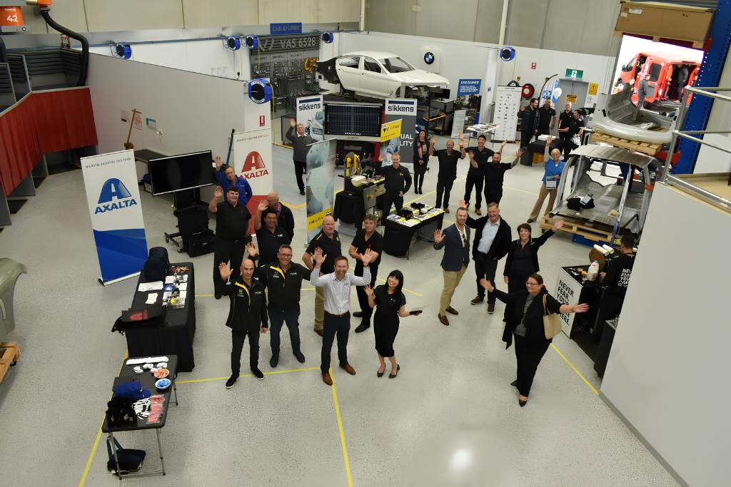 Jason Trewin with collision repair professionals at an automotive industry training and networking event.