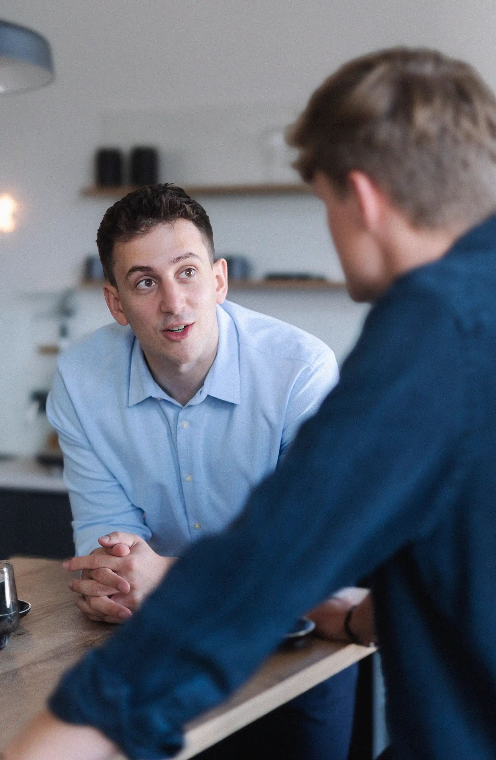 Two men talking with each other.