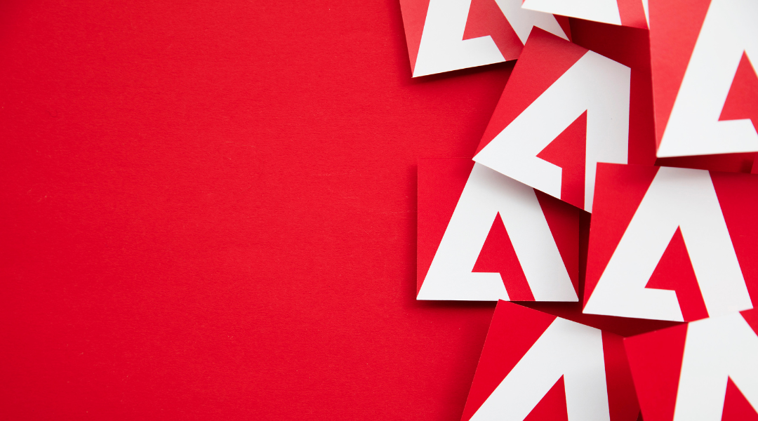 A bunch of Adobe logos scattered on a red background