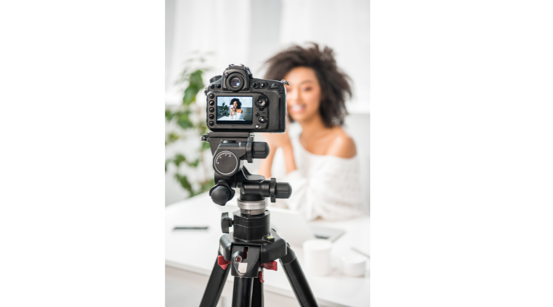 A woman recording herself on a tripod