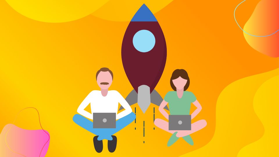 2 persons on their laptops next to a rocket ship.