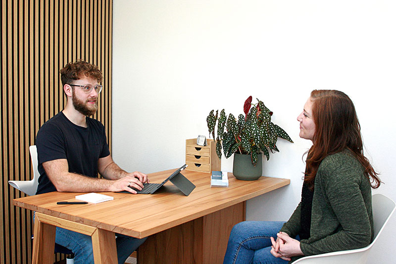 Physiotherapeut beim Beratungsgespräch mit Patientin