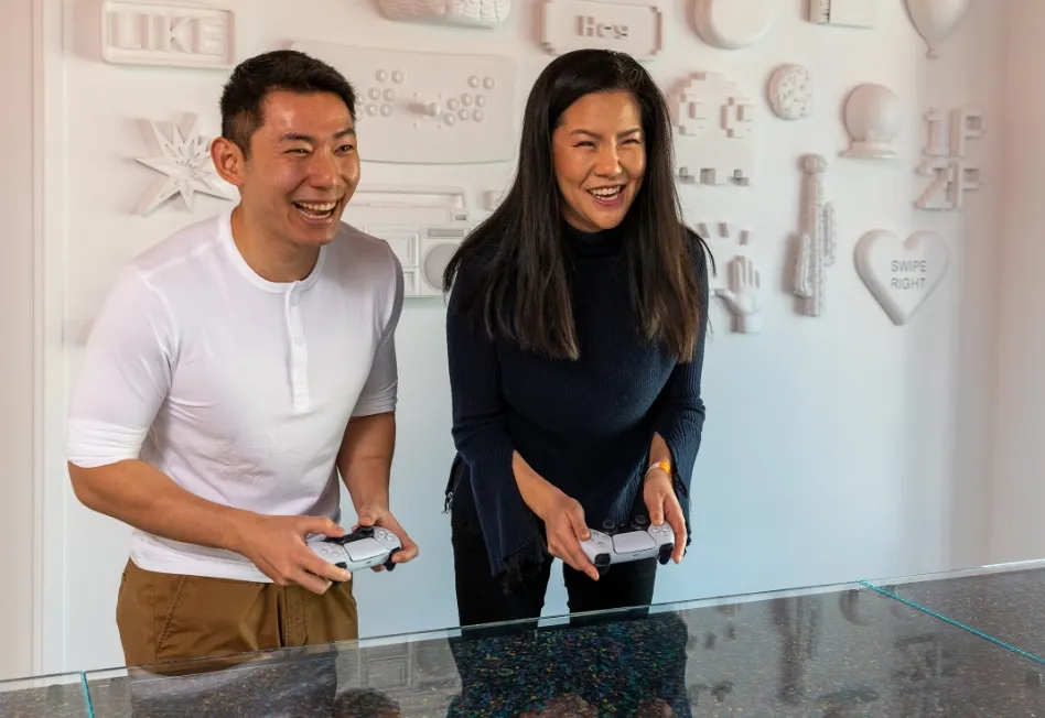 Two Tinder employees playing video games at the Tinder office.