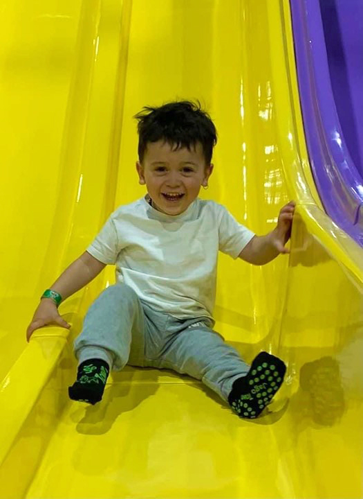 Preschooler looking through cardboard binoculars