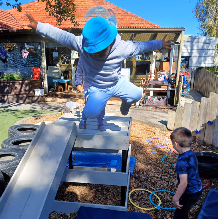 Preschooler jumping in playground
