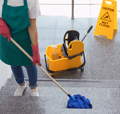 Technician cleaning a stairwell.