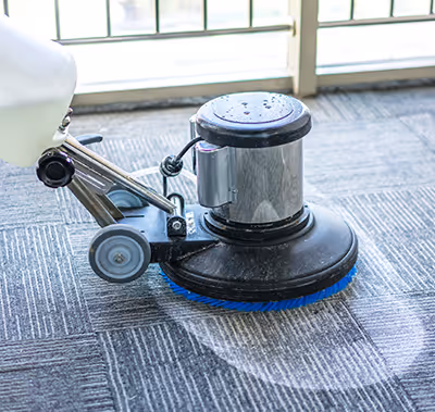 Technician cleaning carpet.