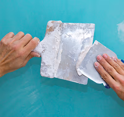 Technician making a drywall repair.