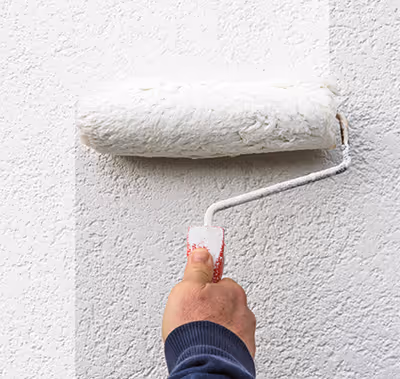 Technician painting a wall.