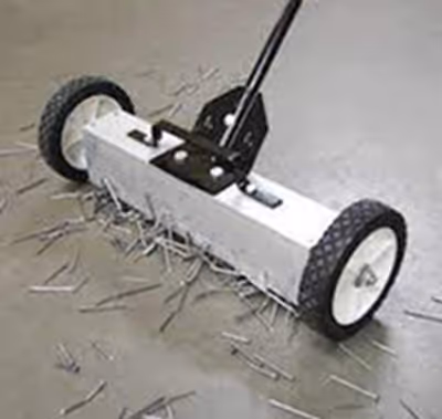 Technician clearing metal fragments using a magnetic sweeper.