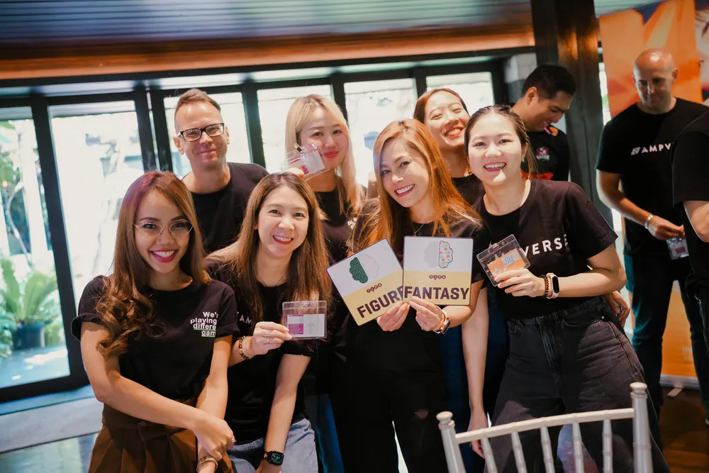 Ampverse team members smiling and holding up their TIPS style cards