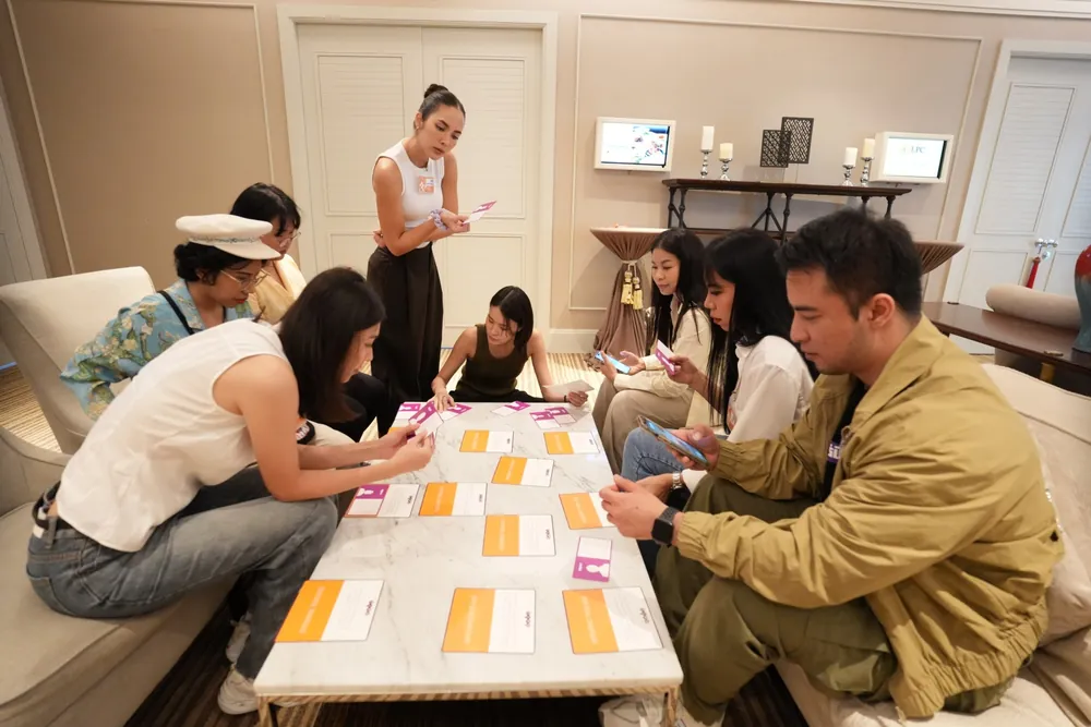 Square 44 workshop participants laying out TIPS cards on a table