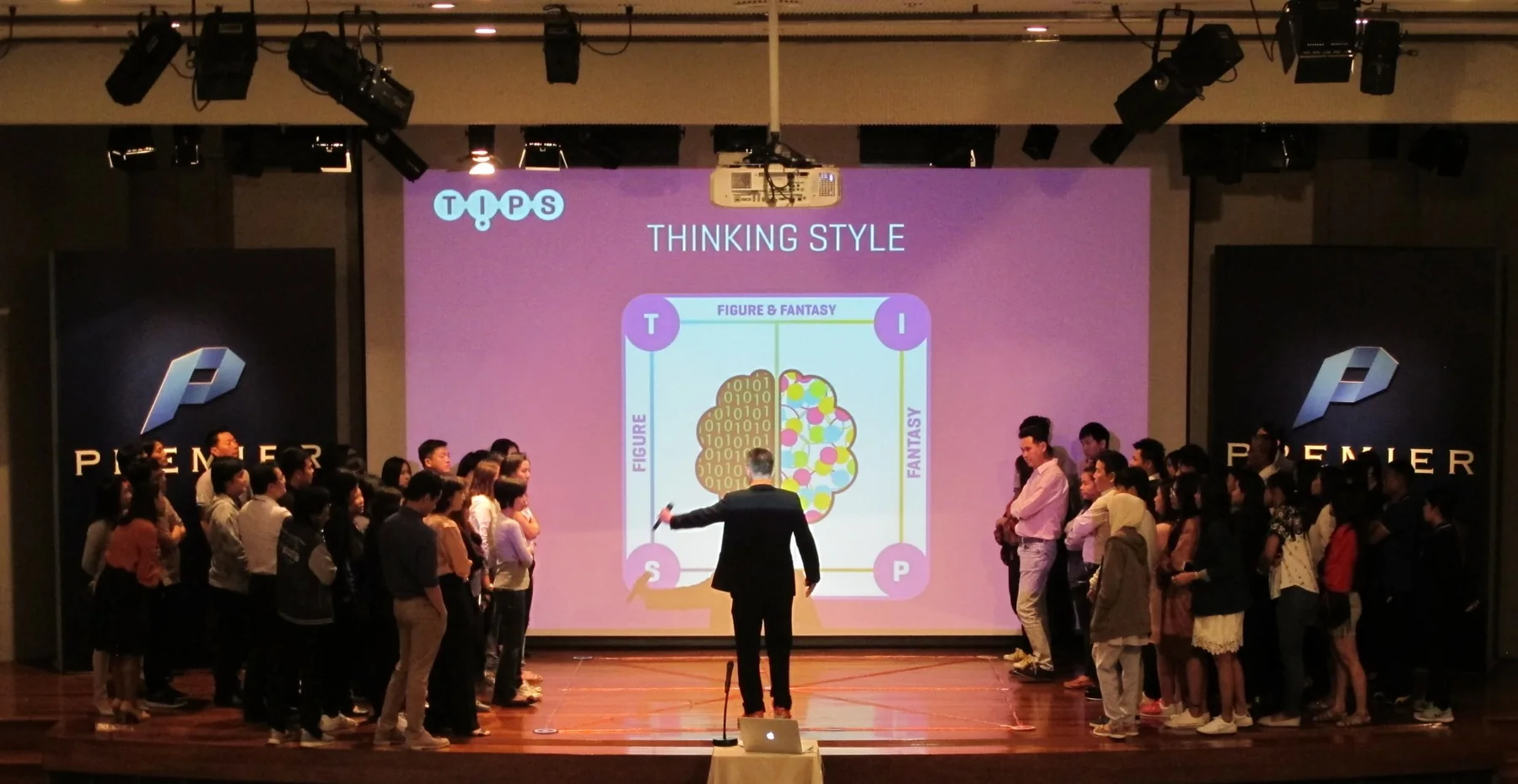 TIPS keynote at Premier: the facilitator on stage divides the audience into two groups by Thinking Style