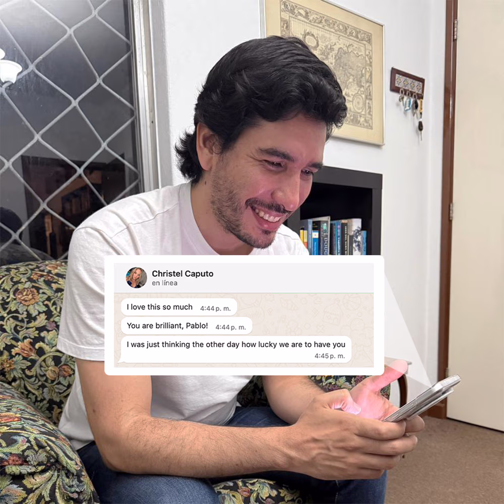 A person looking at their phone smilingly, where they have received a nice message