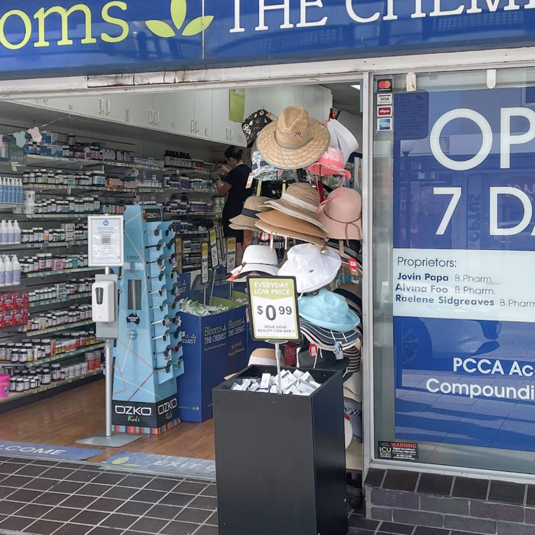A cozy clinic room featuring a comfortable couch with pink pillows, creating a warm and inviting atmosphere.