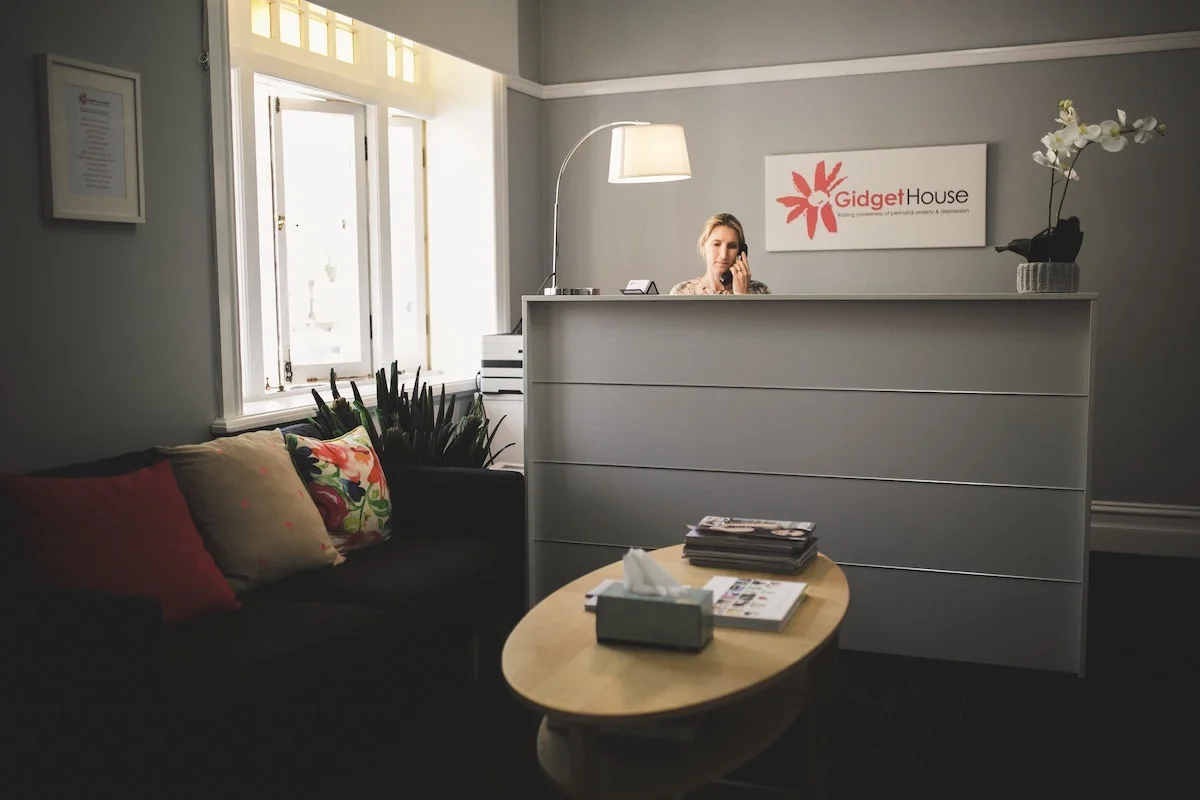 Woman answers the phone at the front desk.