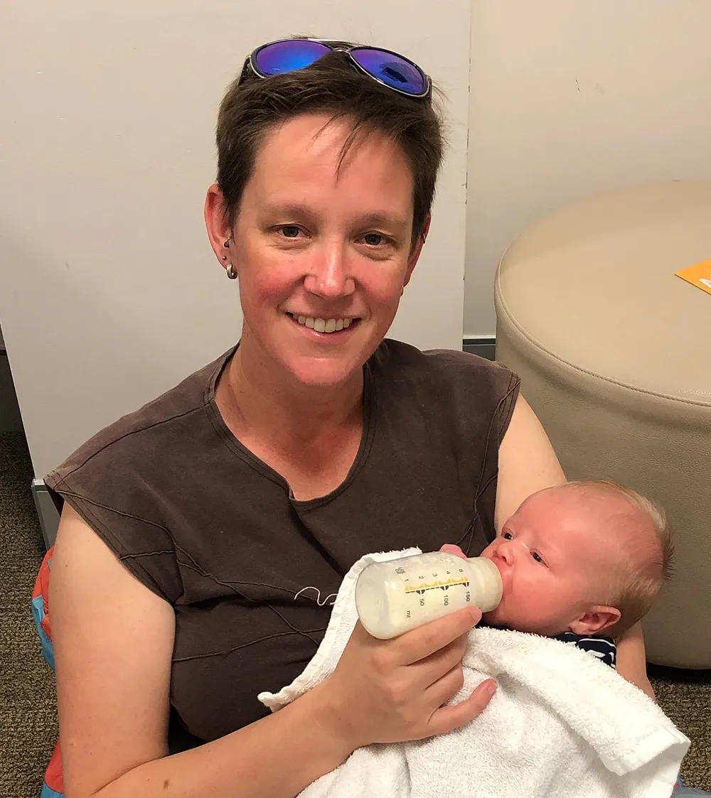 Joy kisses her toddler son tenderly.