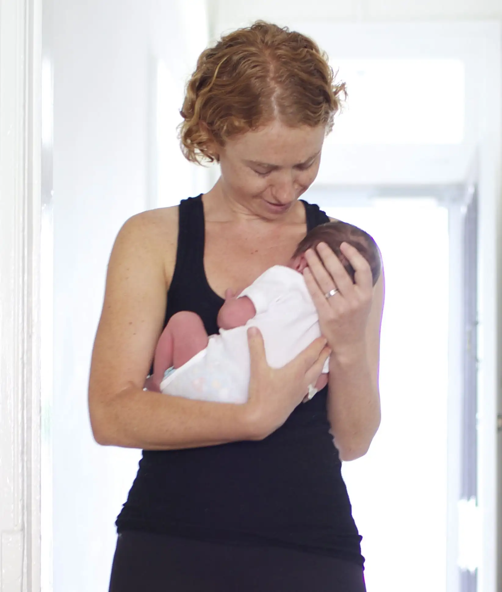 Joy kisses her toddler son tenderly.