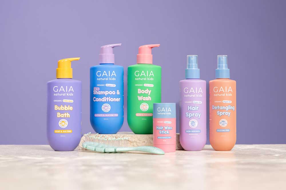 Six colorful GAIA natural kids product bottles including bubble bath, shampoo, body wash, hair spray, and detangling spray.