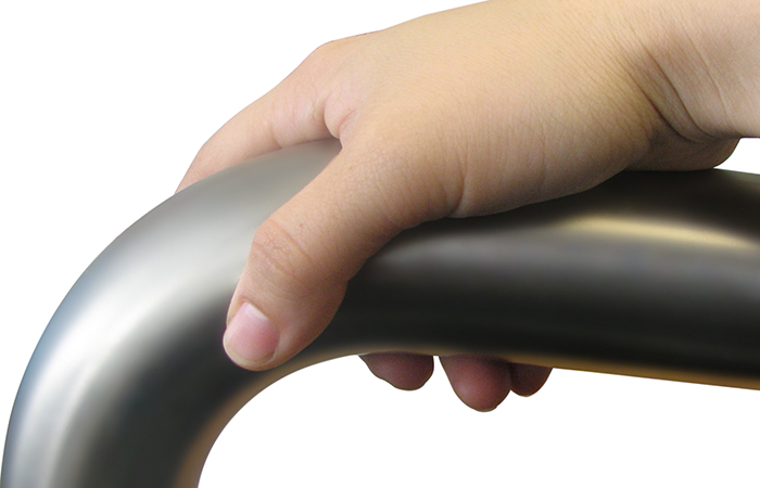 Photo of a hand on a bent tube hand rail.