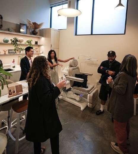 Guests chatting and mingling inside a studio space during the open house