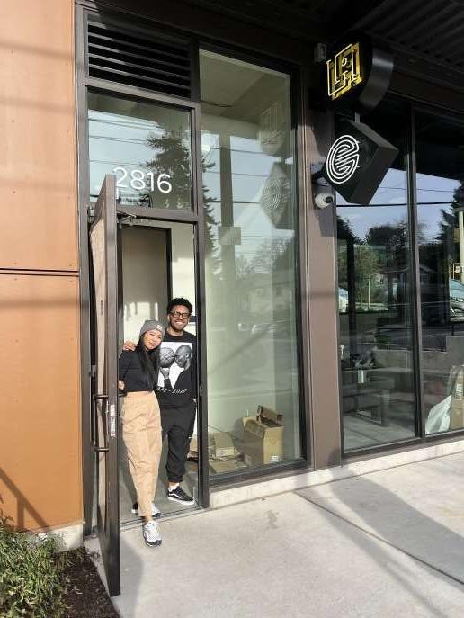 Sonia-Lynn and a colleague standing together in the doorway of the new Emblem Skincare storefront, marked with the address '2816' and the La Union Studio logo above