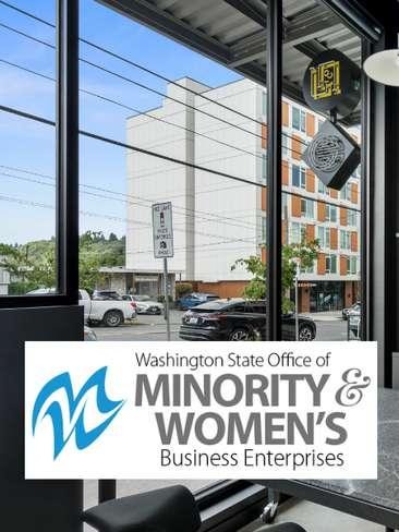 Interior view through a glass storefront window with the Washington State Office of Minority & Women's Business Enterprises logo displayed