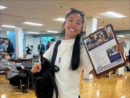Woman holding a clipboard and flyer at the City of Seattle Capital Consultant Connection open house