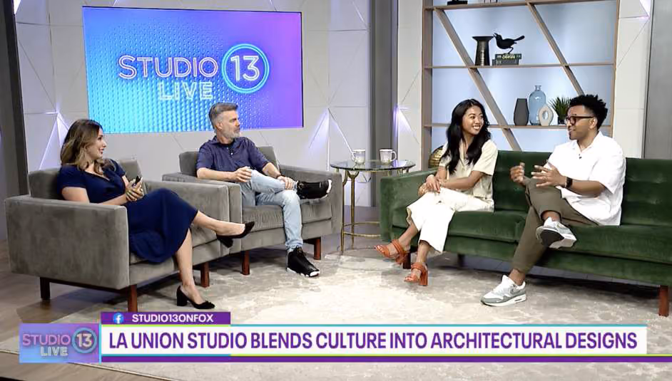 Television interview set showing four people seated on couches, with an on-screen graphic reading 'La Union Studio blends culture into architectural designs'