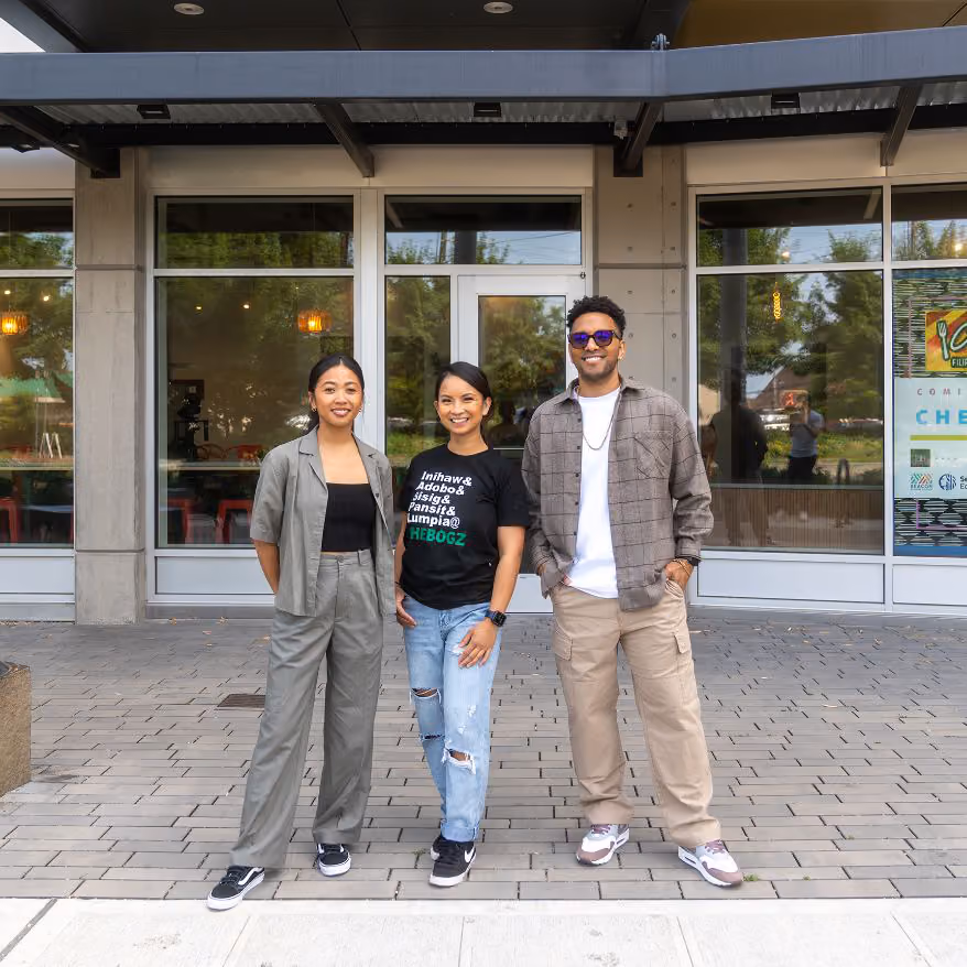 Patrixia Paraiso and two others standing outside the CheBogz Filipino Food storefront