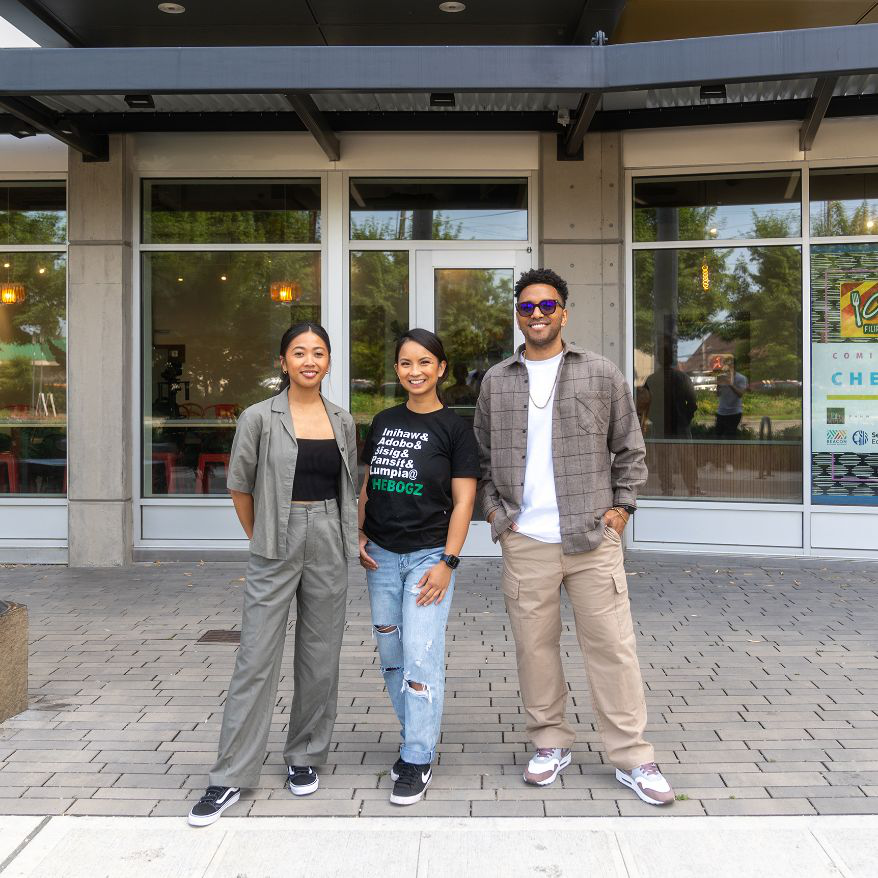 Patrixia Paraiso and two others standing outside the CheBogz Filipino Food storefront