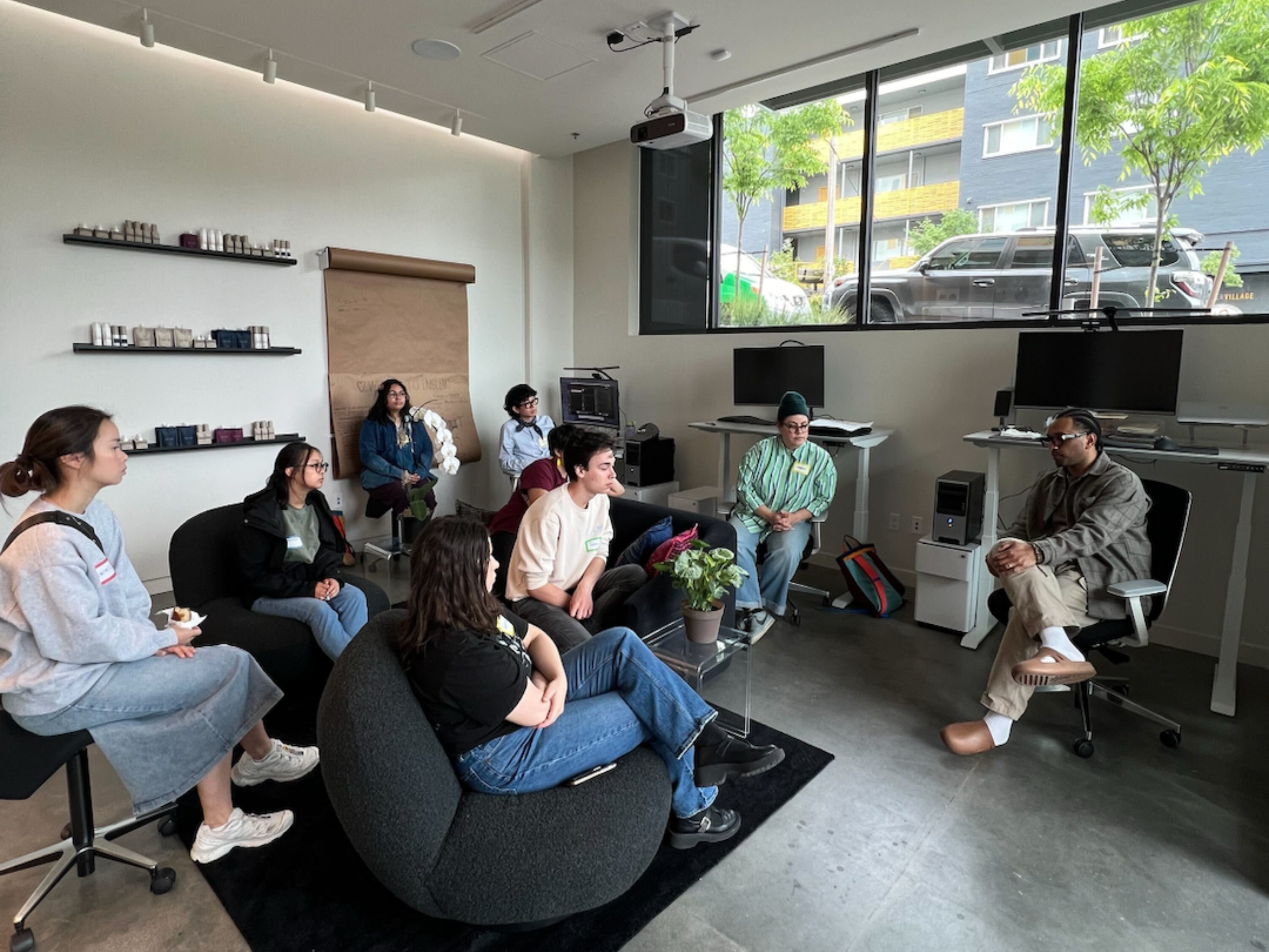 Architecture students and La Union Studio team seated together in the studio lounge during a firm tour