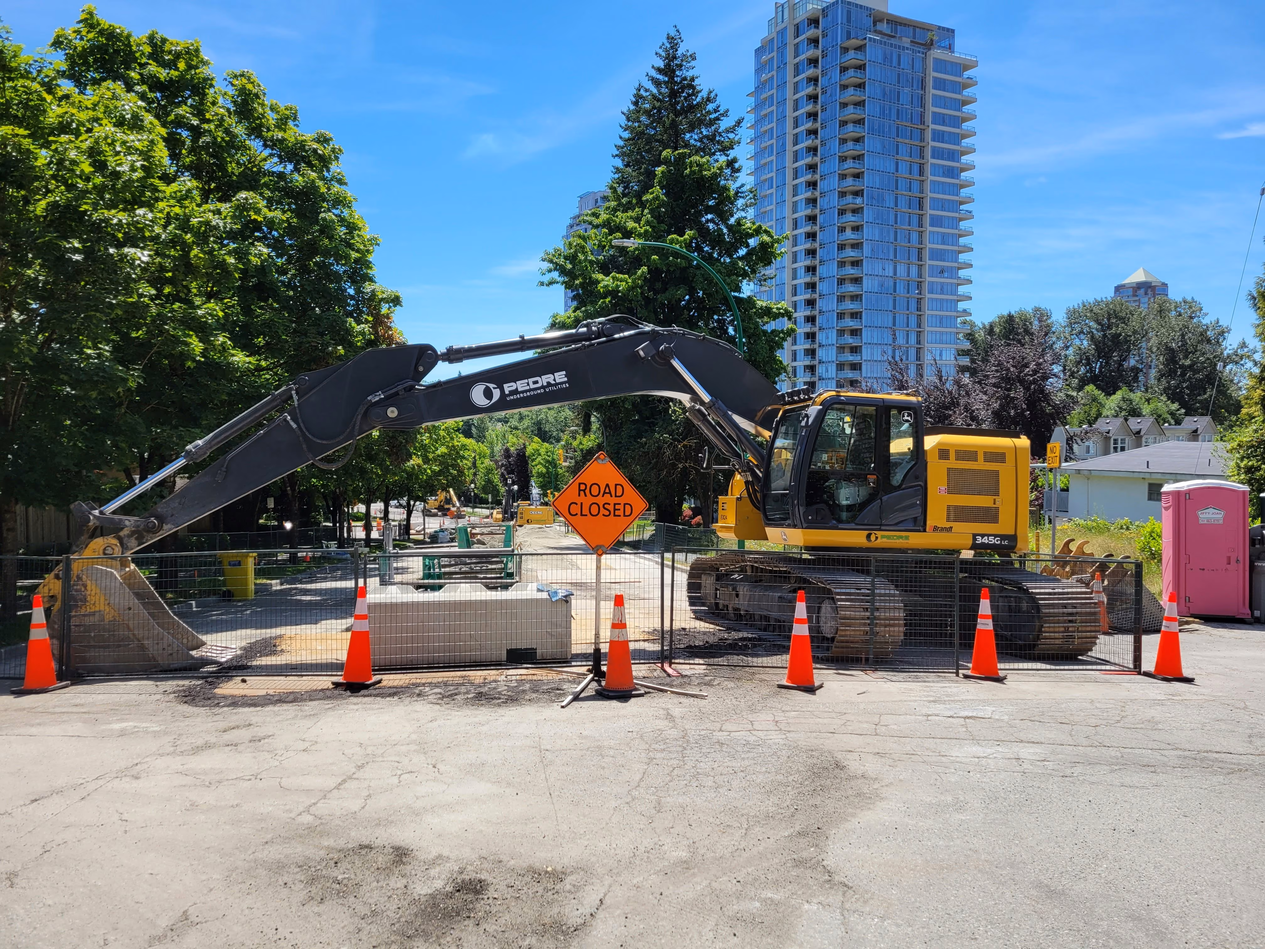 Trench for a new water main in front of homes in a Seattle neighborhood.