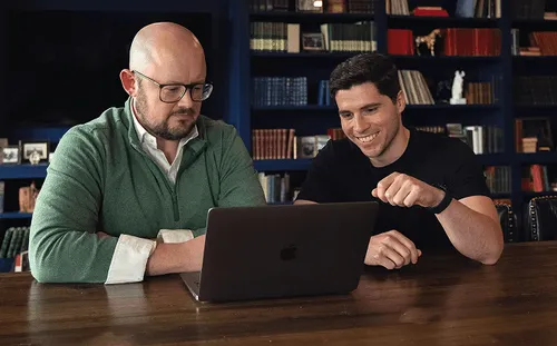 Bonsai team members Luis César Cordova and Matt Gross sit at the laptop