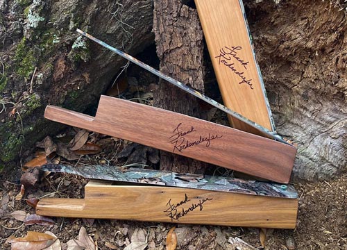 3 turkey calls stacked in the woods showing the aluminum paddle 