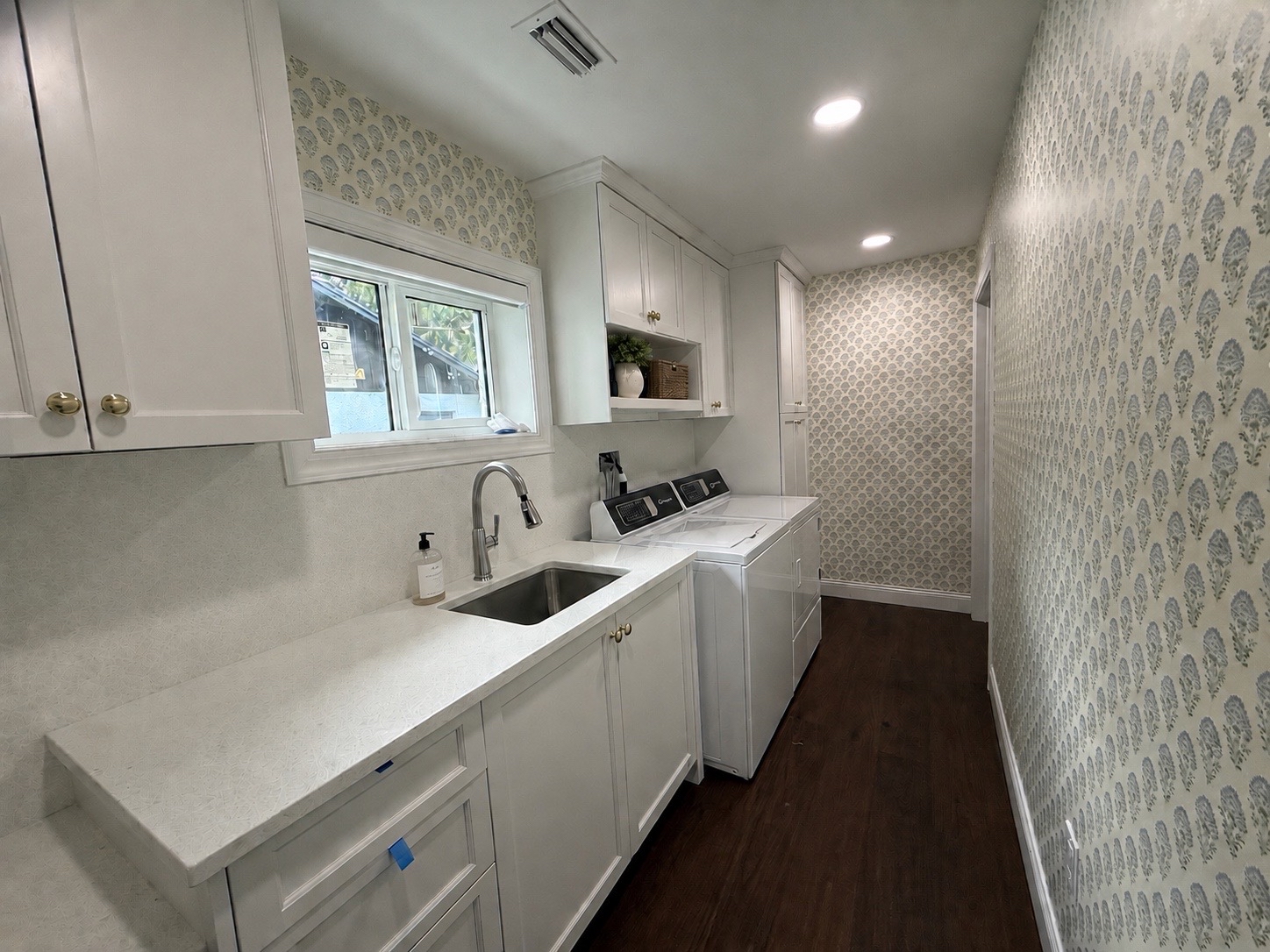 custom white cabinets and countertops in laundry room 