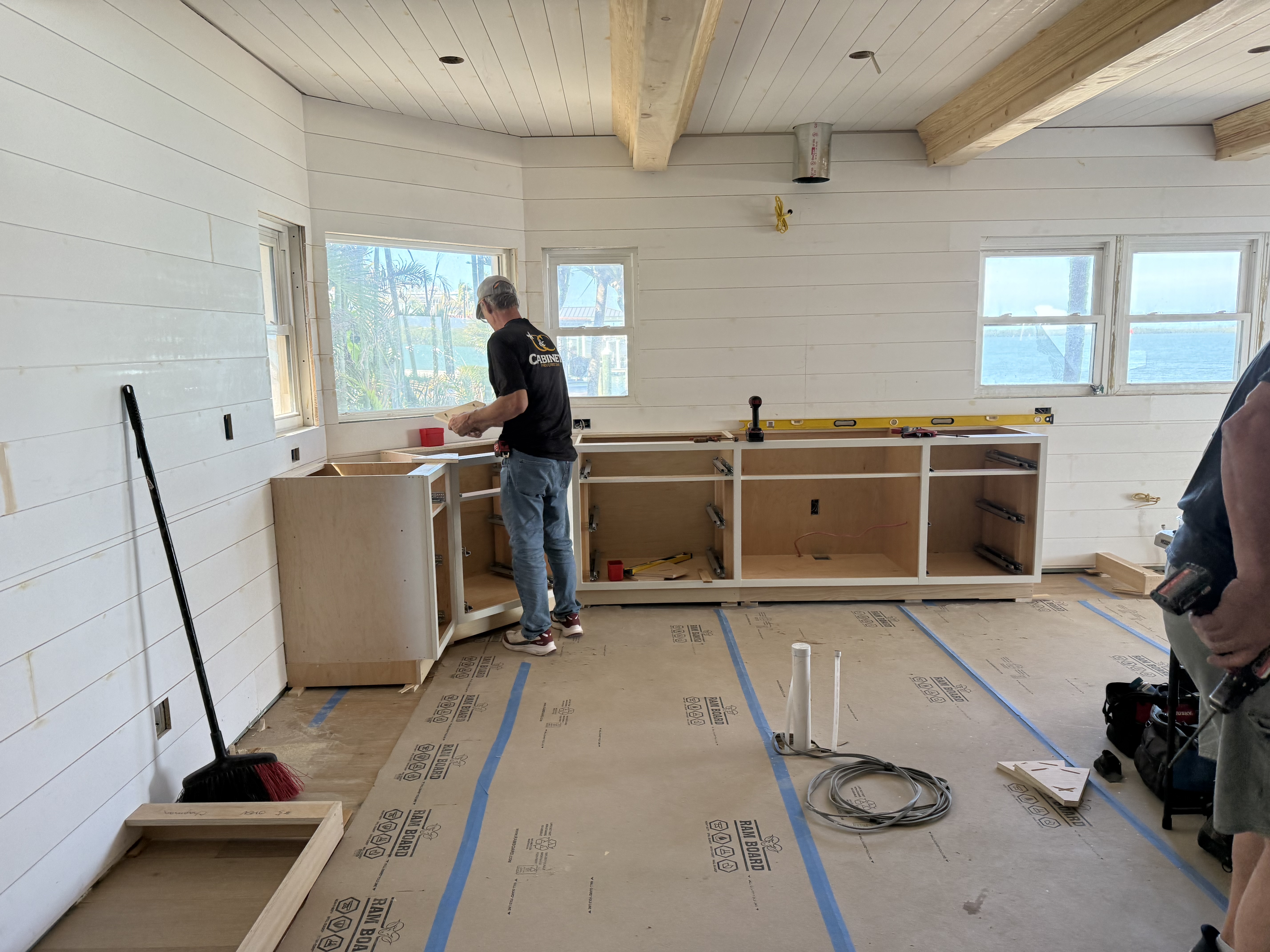 Cabinet craftsman working on cabinets in kitchen