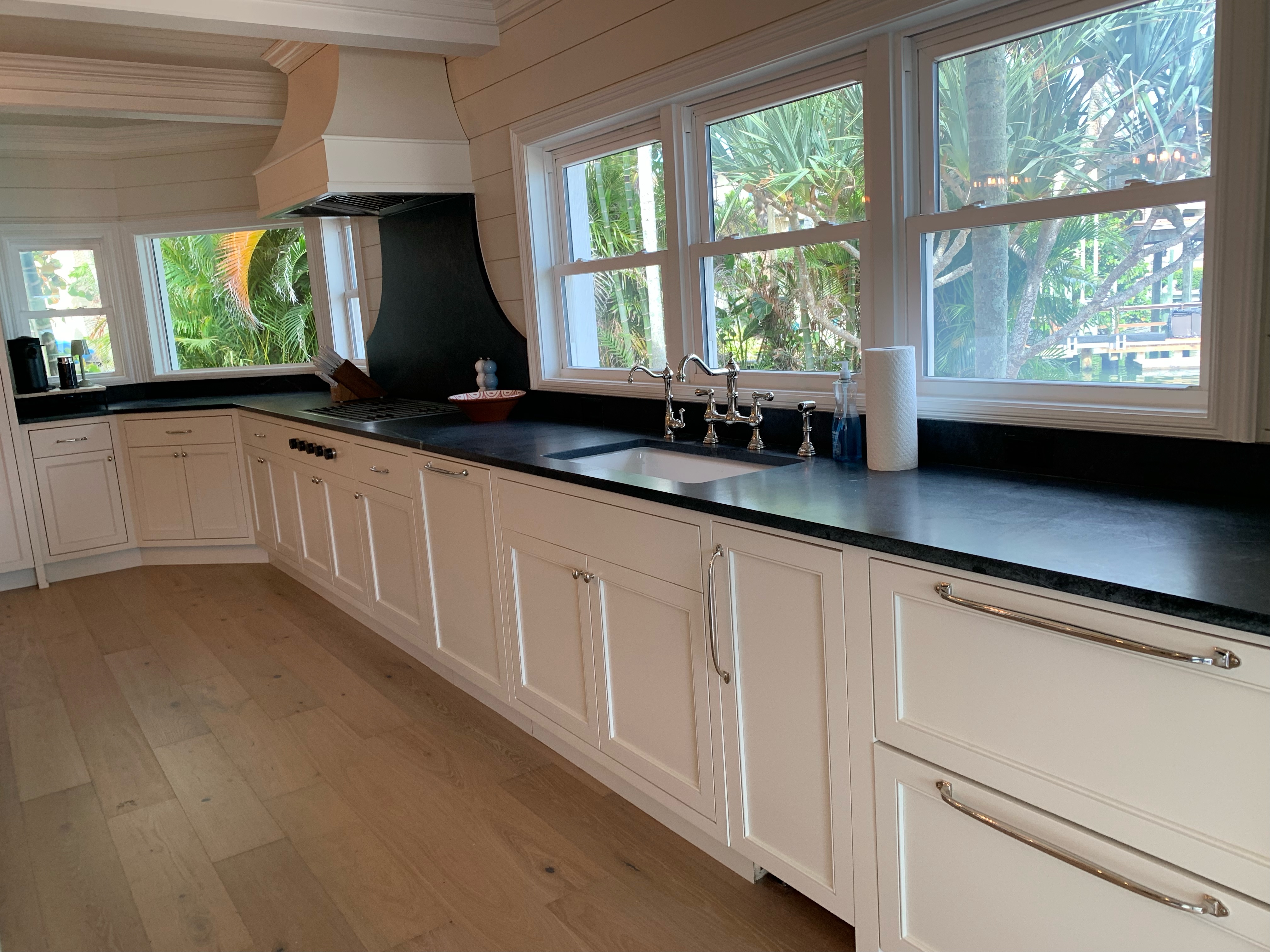 white cabinets in kitchen with black granite countertops
