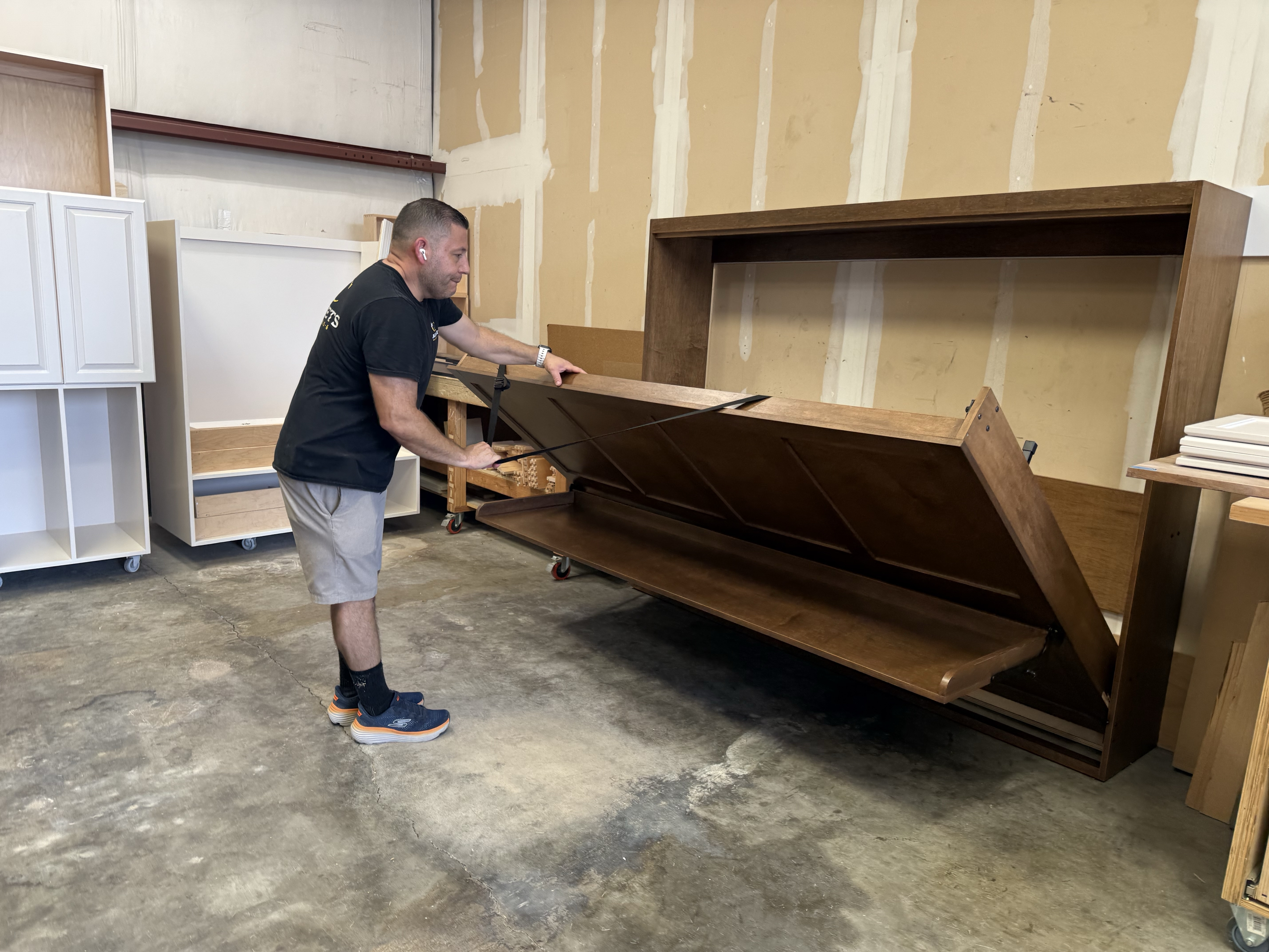 carpenter testing a completed murphy bed
