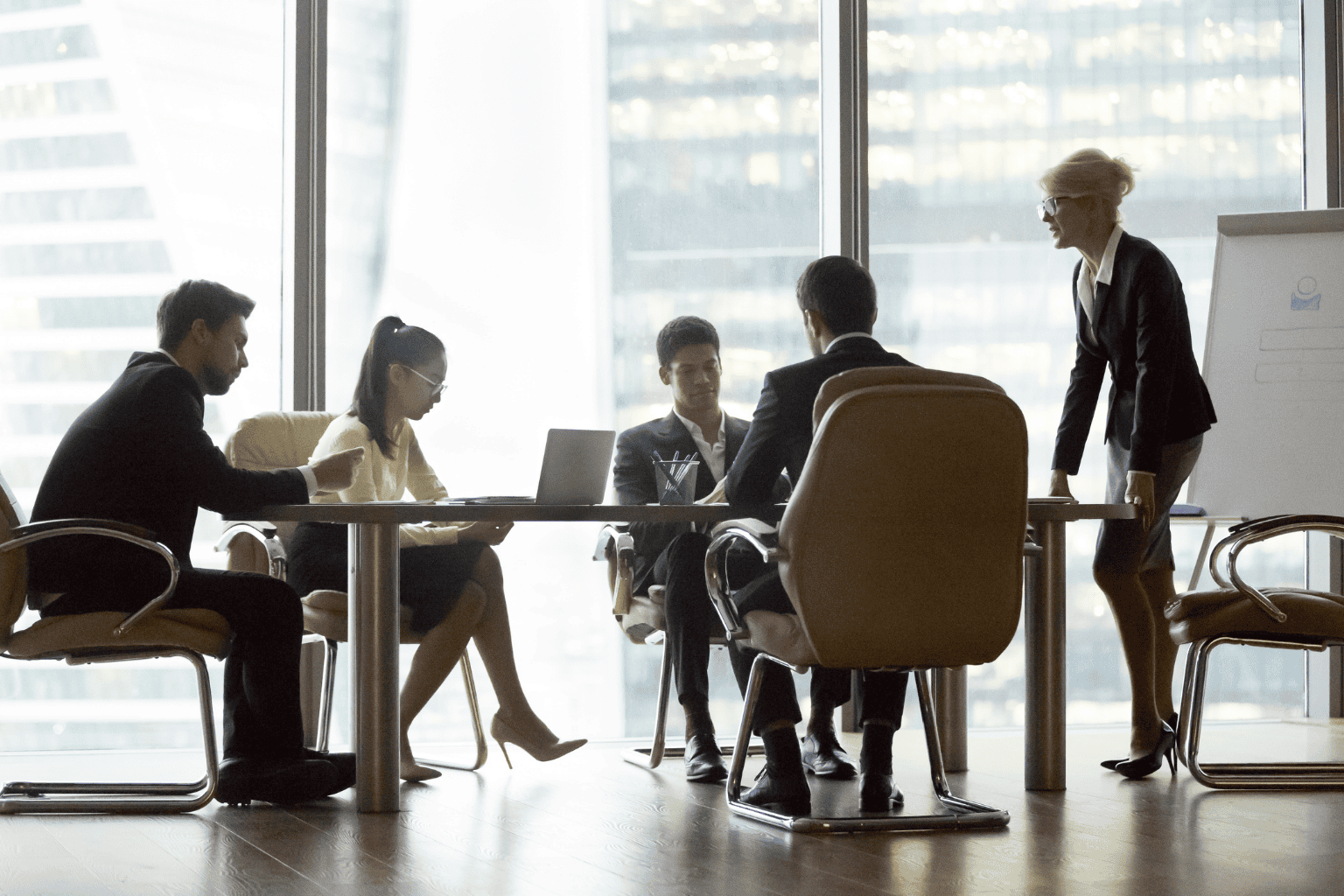 Group of people in an office conference room gathered around a table
