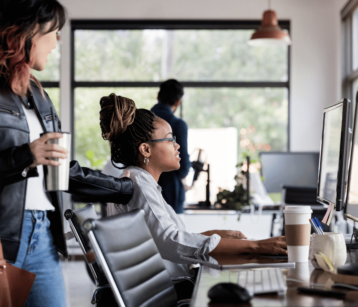 Two young professionals looking at computer in office