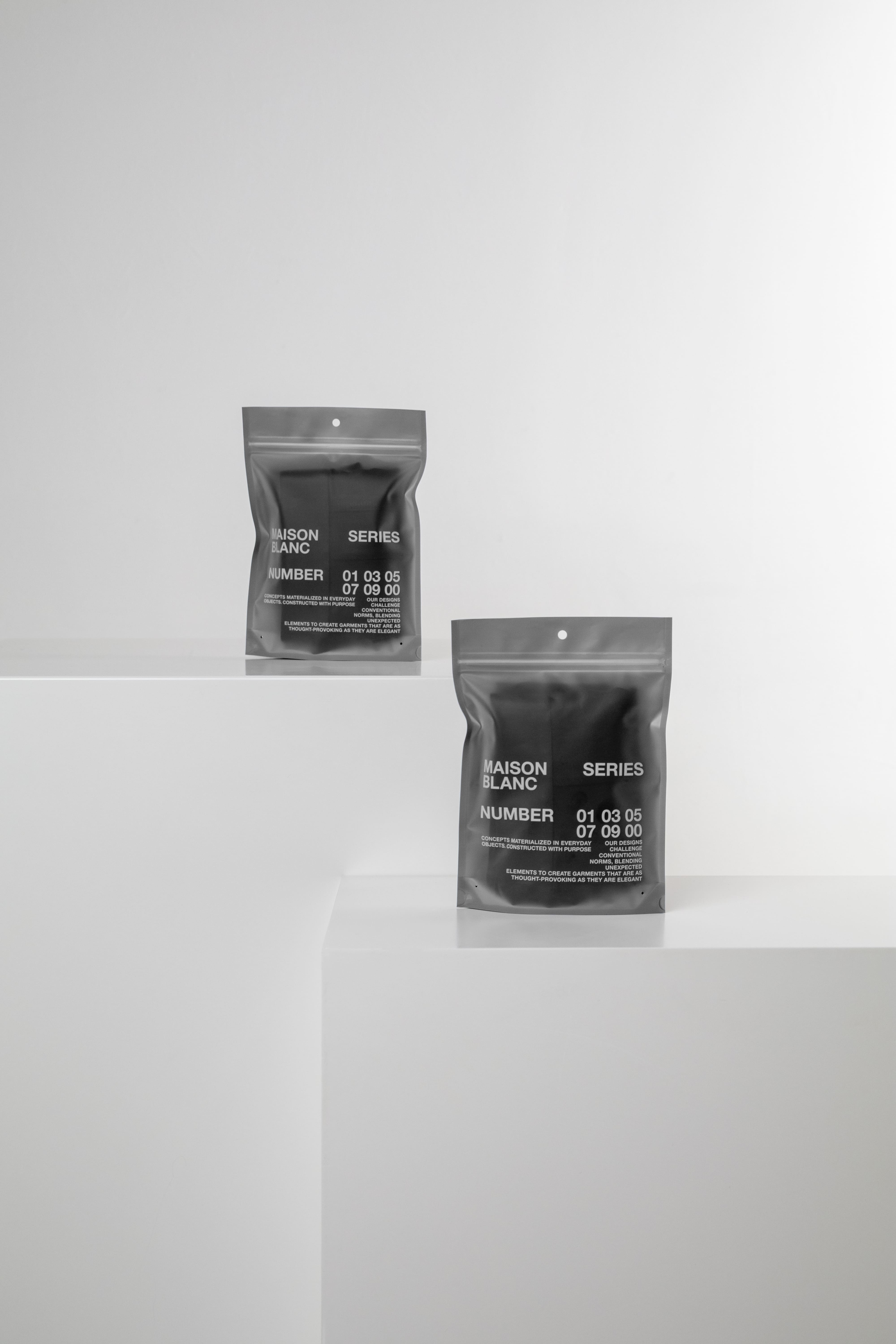 Black-and-white Maison Blanc Series pouches featuring numbered packaging and minimalist geometric presentation, showcasing contemporary packaging design.