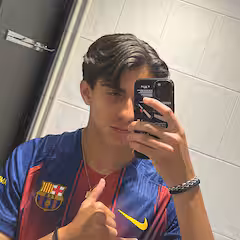 Two people kayaking on a calm lake with mountains in the background.