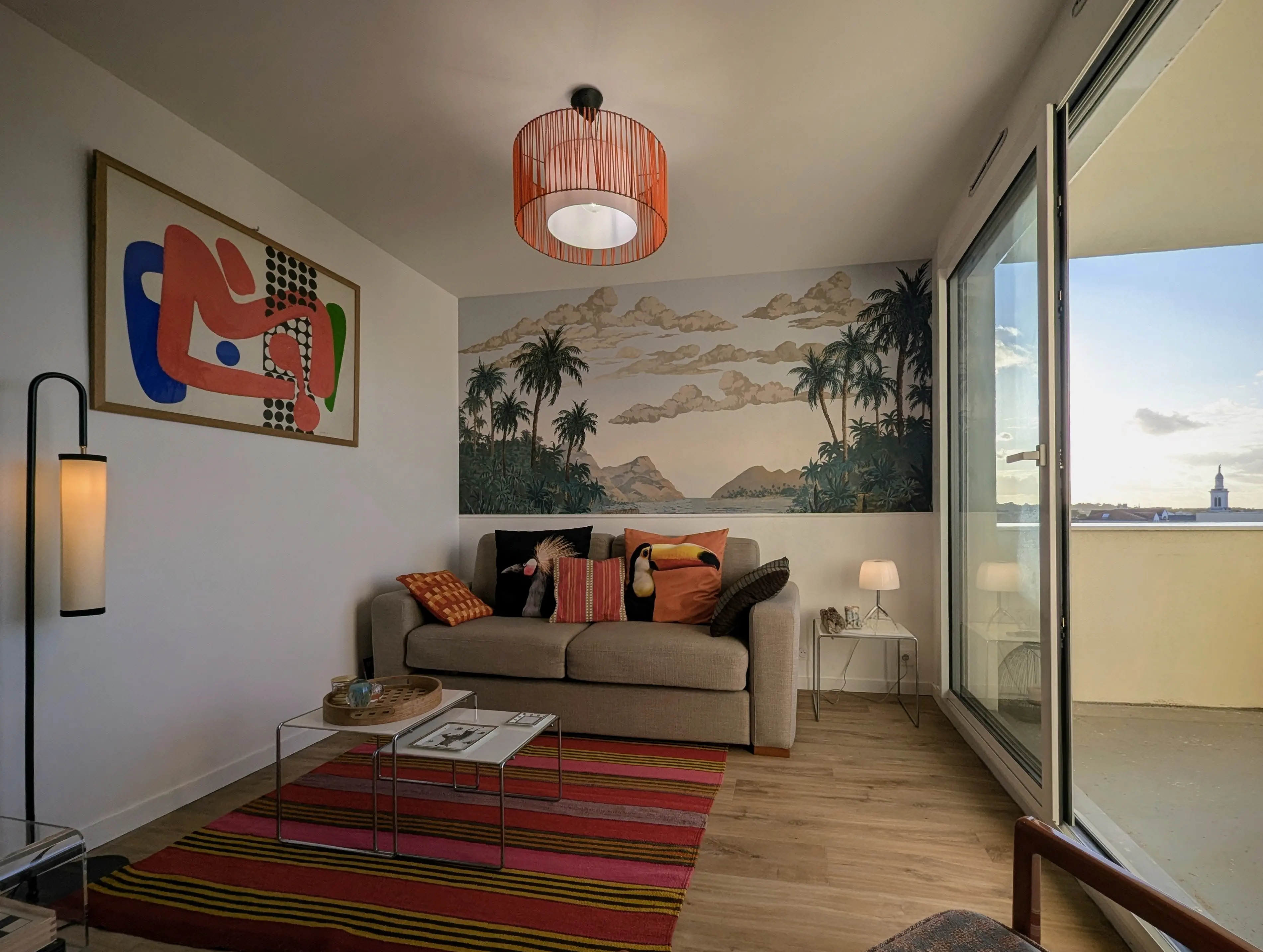 vue de la partie séjour d'un studio rénové à Arcachon, papier peint panoramique Palmier Impérial.
