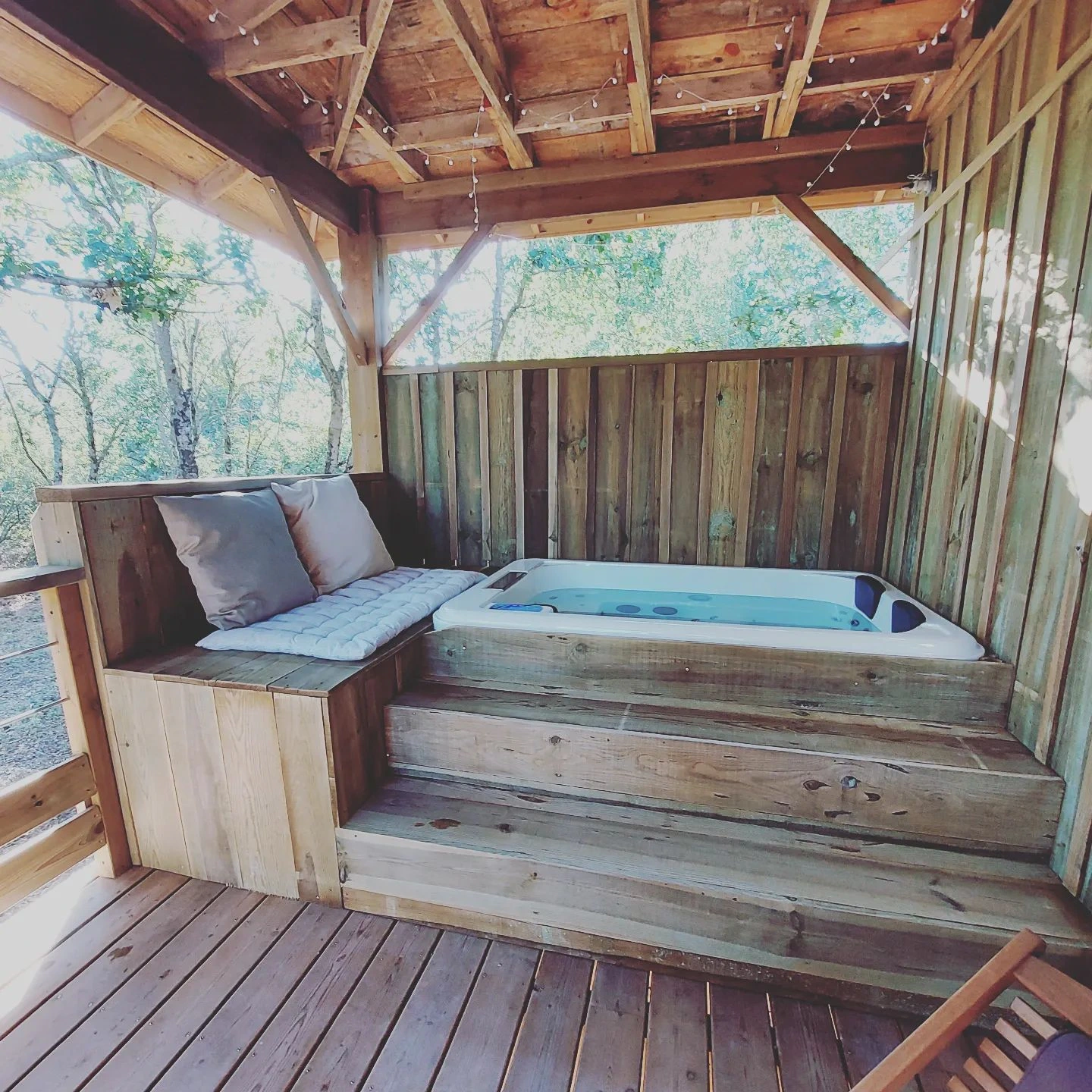 jacuzzi sur la terrasse d'un gîte sur pilotis