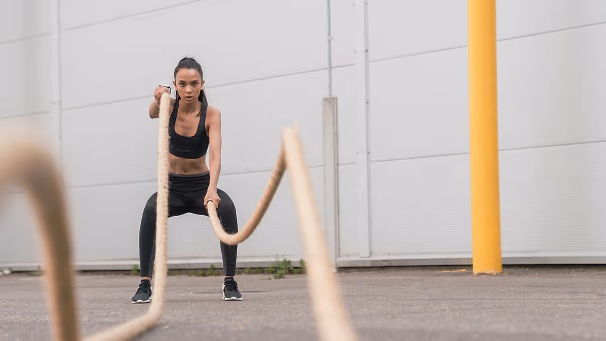 Woman working out with battle ropes