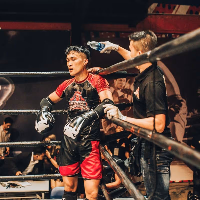MMA fighter taking a break in the ring
