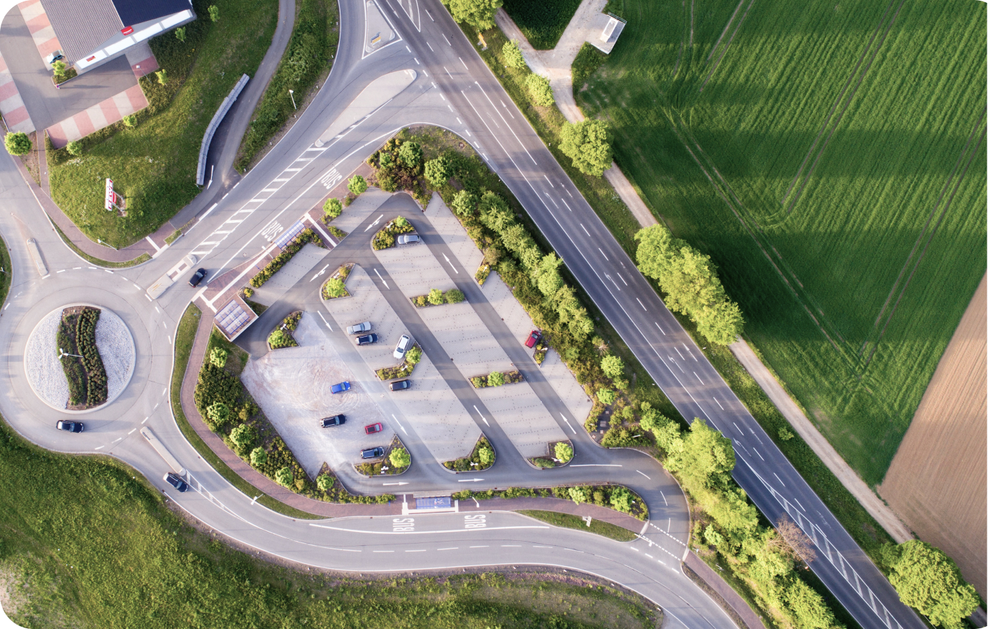 An overhead shot of a parking lot and the land around it.
